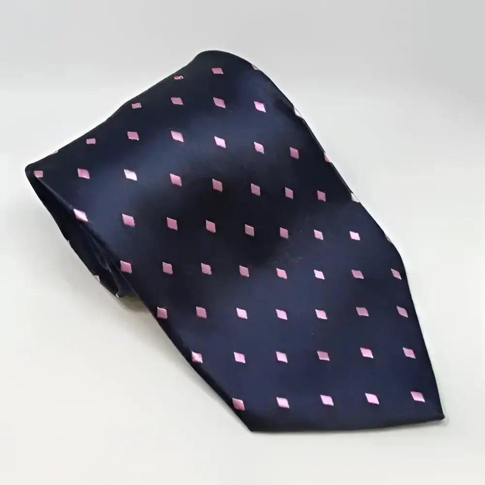 A navy blue silk equetech adult diamond showing tie with small pink and white diamond shaped dots riding tie