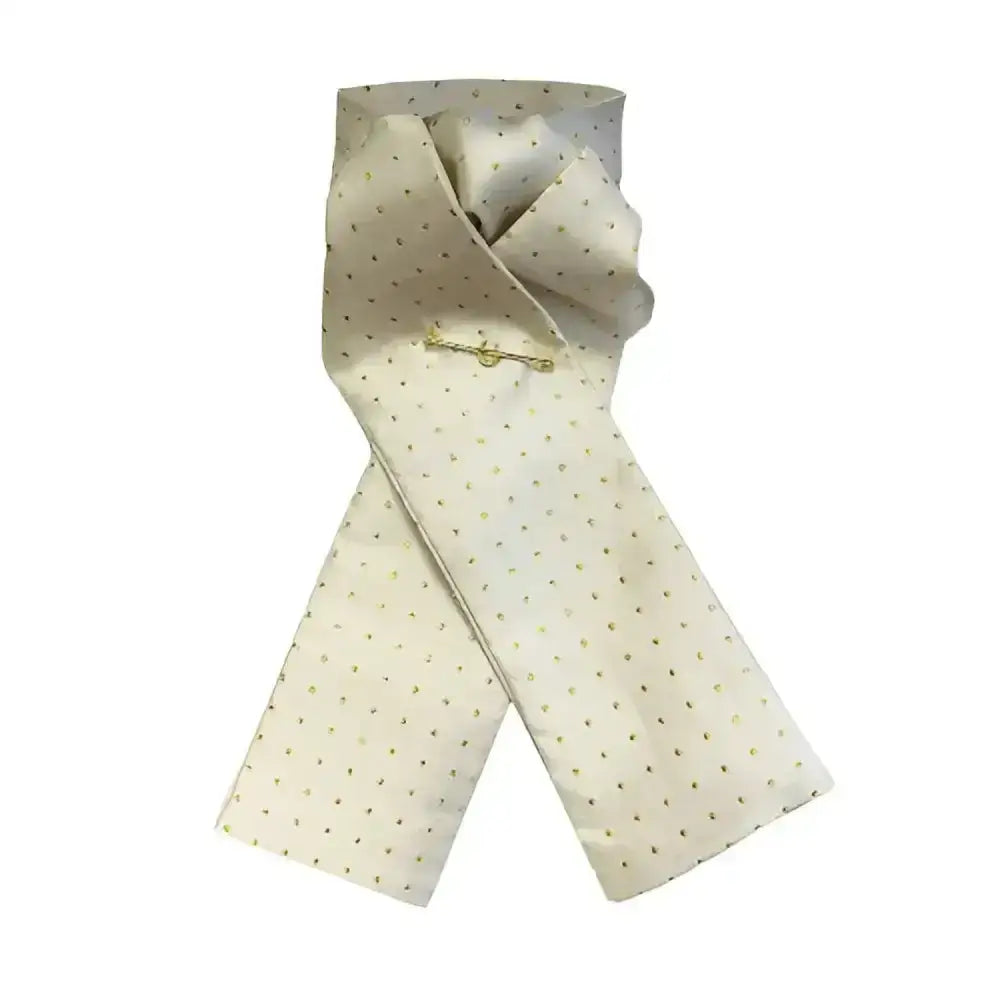 A cream silk equetech pin spot riding stock cream tie with subtle gold polka dots and a delicate gold pin