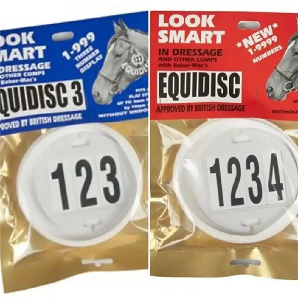 White circular equidisc competitor number discs with black digits packaged in clear sleeves for horse competitions