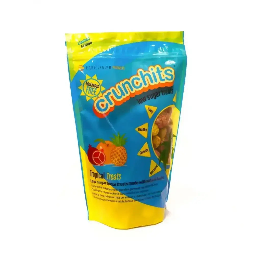 A vibrant blue and yellow glossy plastic pouch of equilibrium crunchits tropical horse treats with colorful fruit illustrations