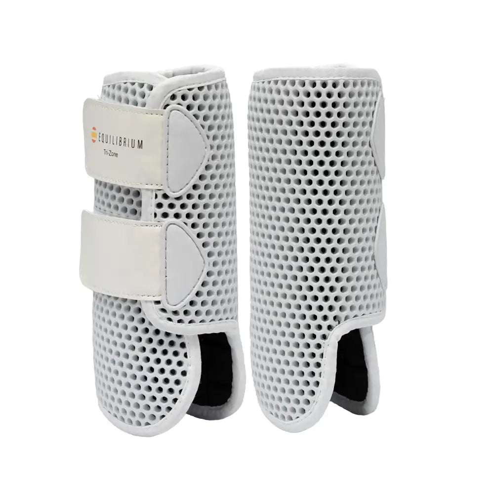 White equilibrium tri-zone horse leg guards with perforated mesh and adjustable velcro straps perfect all-rounder boots