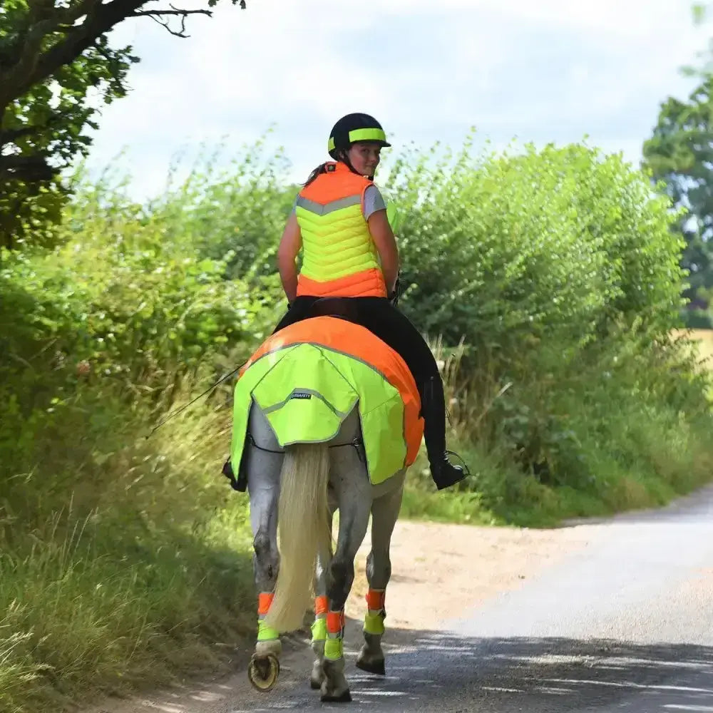 Bright neon green and orange reflective horse riding vest with quilted design from equisafety breathable mesh quarter sheet line