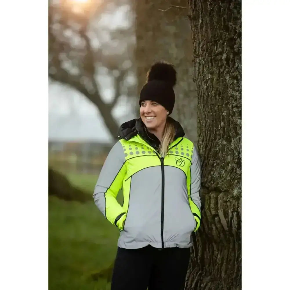 Equisafety Mercury lightweight reflective riding coat in neon yellow and gray with a black pom-pom beanie