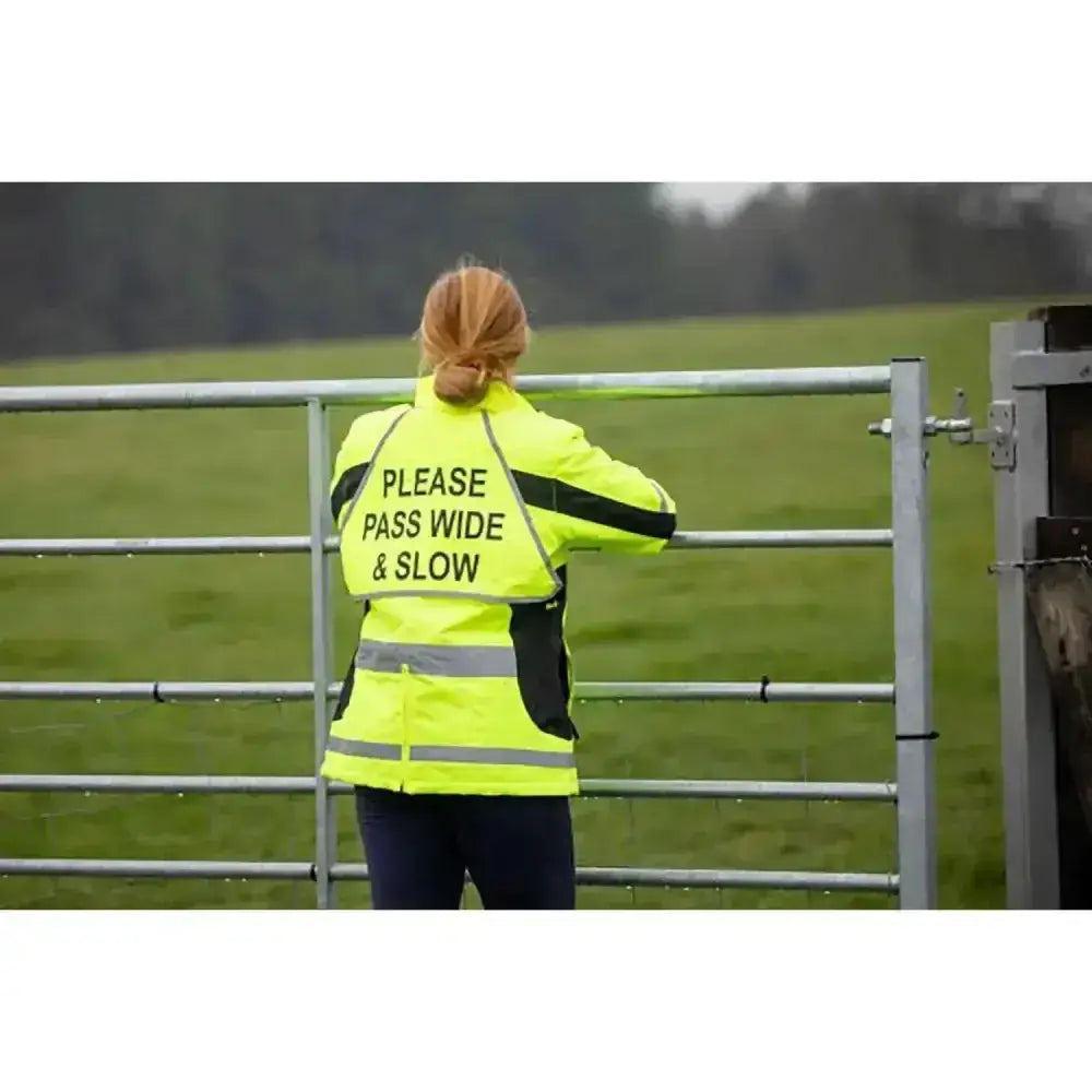 Back view of equisafety winter inverno reflective hi viz riding jacket in yellow with black panels and please pass wide and slow text