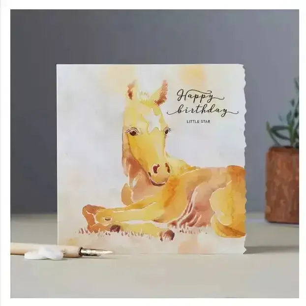 Fanciful dolomite card featuring a golden foal in soft watercolor with happy birthday little star for special occasions