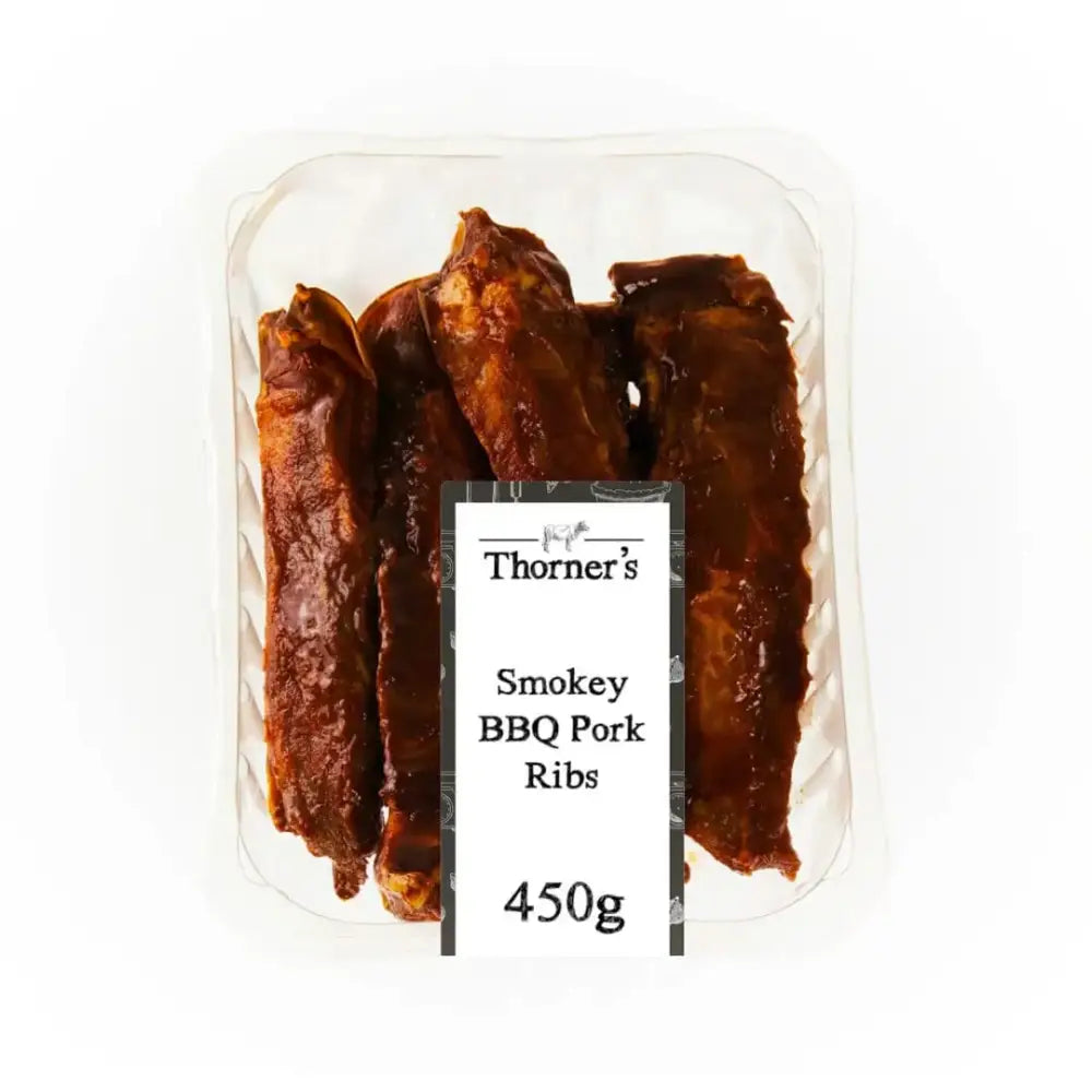 Free range smokey bbq pork ribs in a clear tray coated with glossy dark brown smokey bbq pork sauce