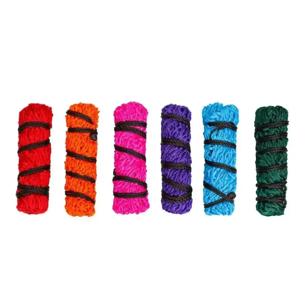 Six colorful textured bundles wrapped with thicker nylon rope in medium gallop haylage net for easy feeding