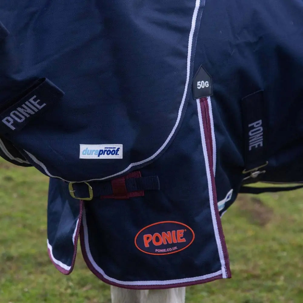 Navy blue gallop ponie duraproof 50g turnout rug with white and maroon trim and standard neck design