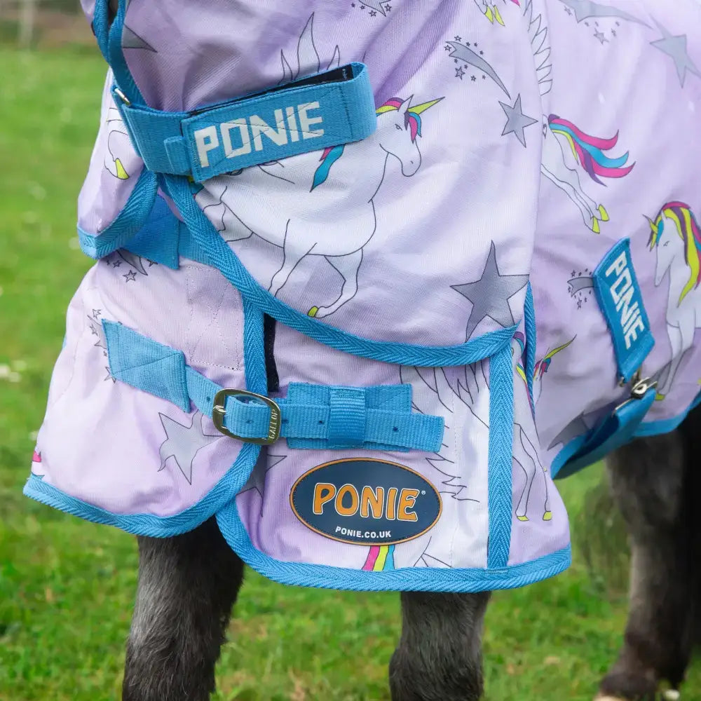 Purple and blue unicorn-themed horse rug with star patterns featuring ponie logo in gallop ponie pegacorn combo fly rug