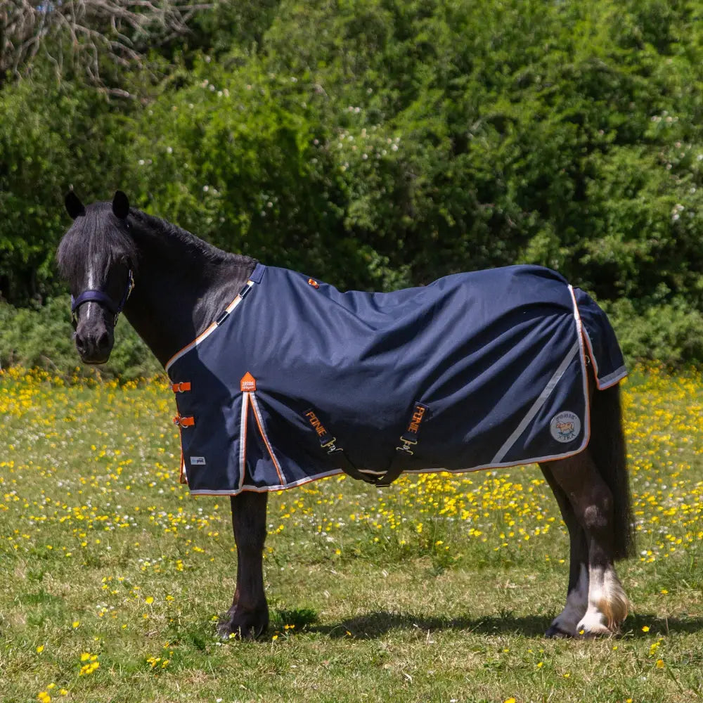 Navy blue gallop ponie xtra duraproof 100g lightweight turnout rug with orange white trim reflective stripes and logo