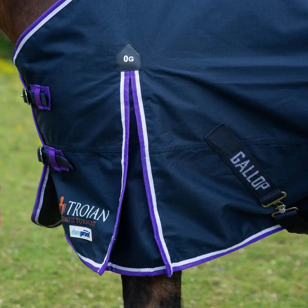Navy blue lightweight turnout horse blanket with purple white trim shoulder pleat and gallop trojan duraproof logo