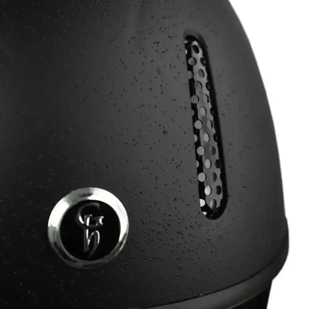 Black matte gatehouse r20 jockey helmet with circular chrome emblem and ventilation slot for cross country rides