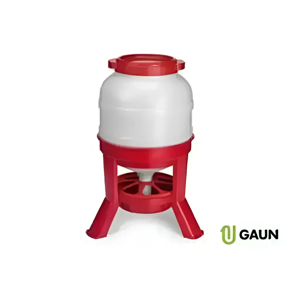 Red and white plastic gaun hopper feeder with dome top and tough feed trough on three-legged base for poultry meals