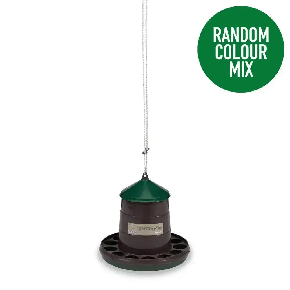Dark green and brown gaun poultry feeder made from recycled plastic with conical top and multiple slots hanging by white string
