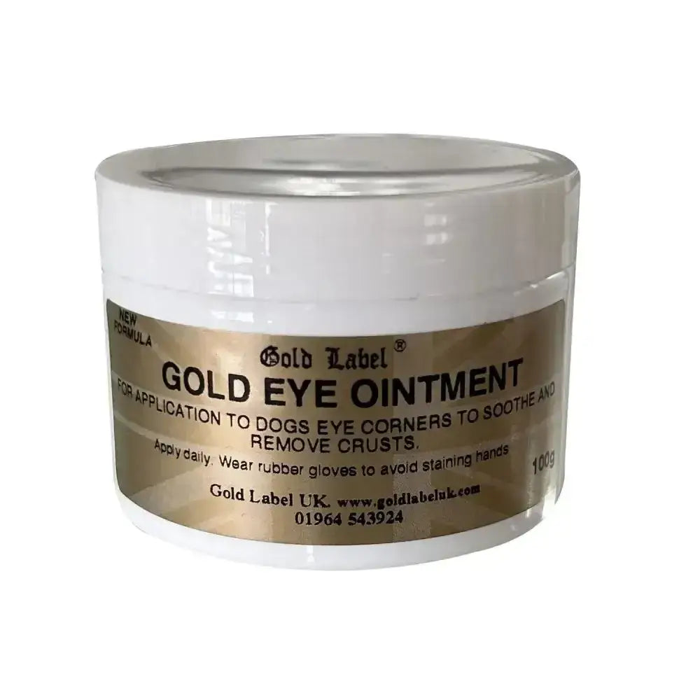 White plastic jar with gold label canine gold eye ointment for applying to dogs eye corners from gold label canine