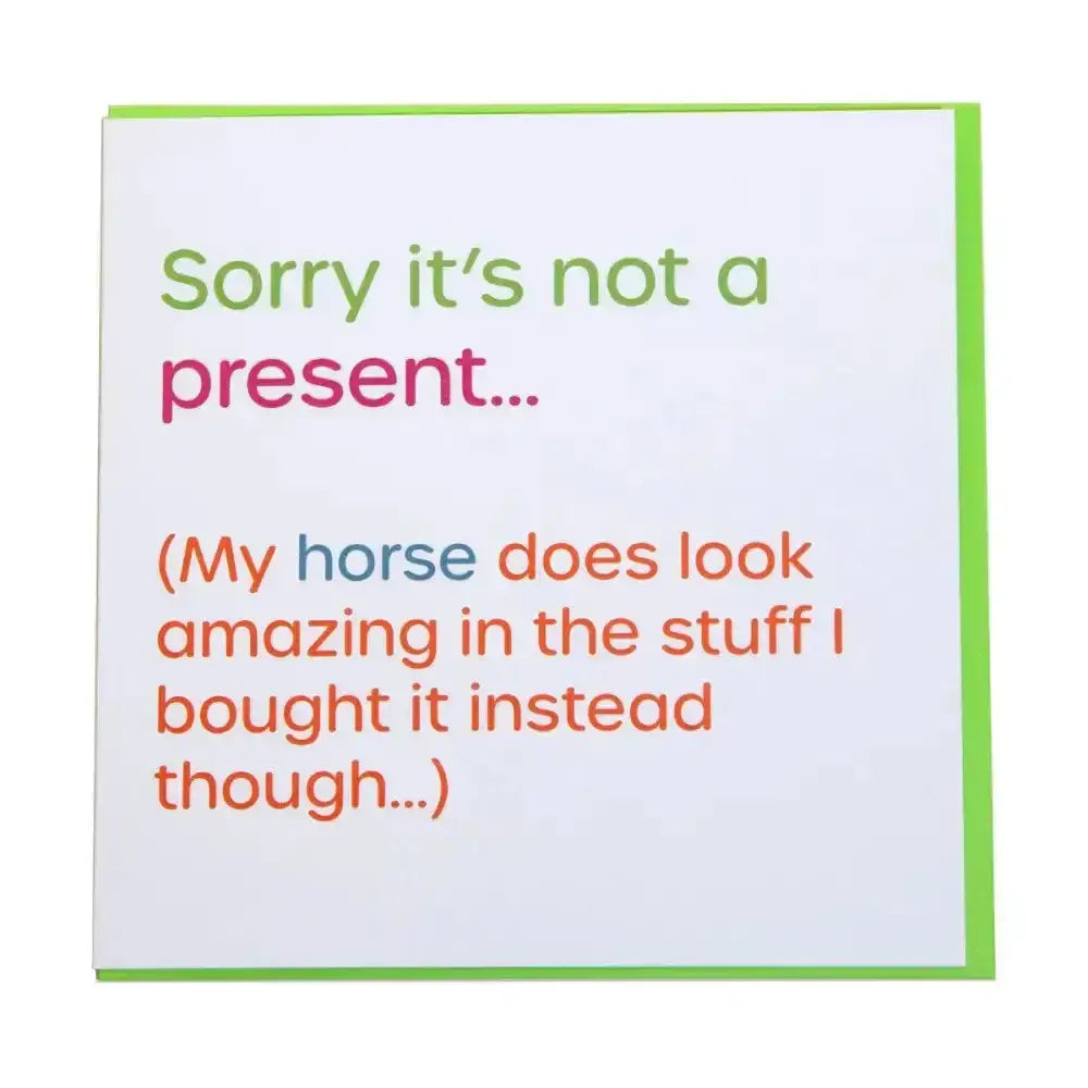 A white gubblecote foiled greetings card with lime green border and humourous foiled text sorry its not a present