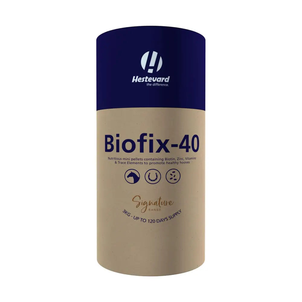 A cylindrical hestevard biofix 40 container with navy blue top and beige body containing horse hoof supplements in mini pellet form