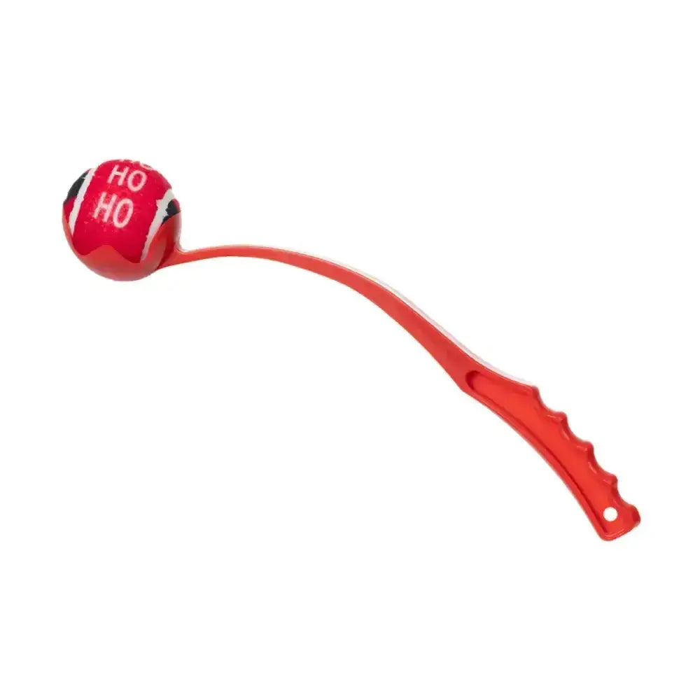 Red plastic paws ball launcher with curved handle and christmas tennis ball head printed ho ho in white letters