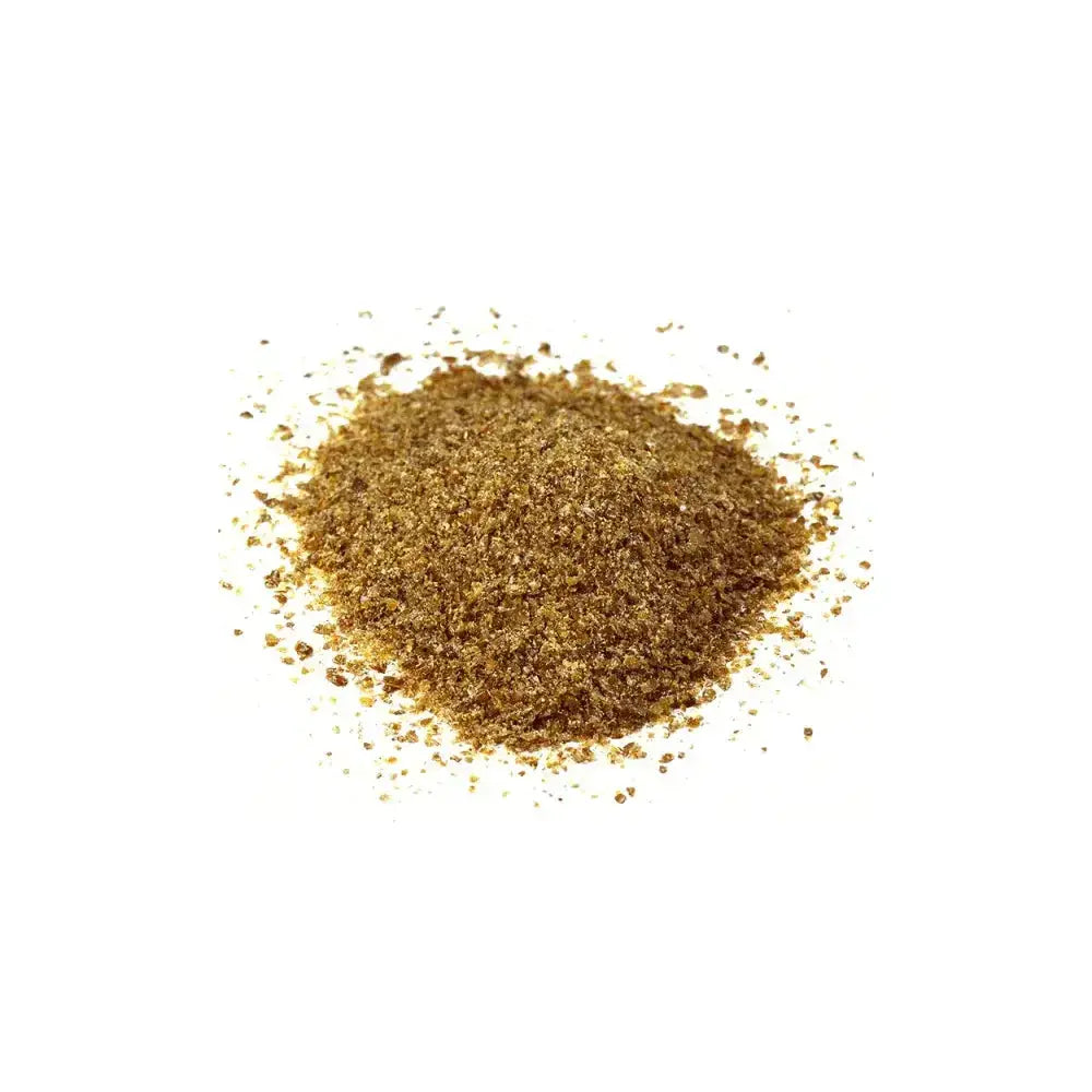 A mound of finely ground golden-brown cooked linseed meal with a textured granular appearance from hutton mill