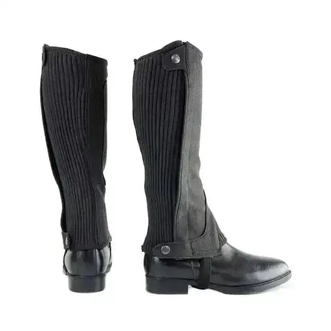 Black ribbed fabric hy equestrian amara half chaps for kids with adjustable snap closures and stretchy amara suede accents