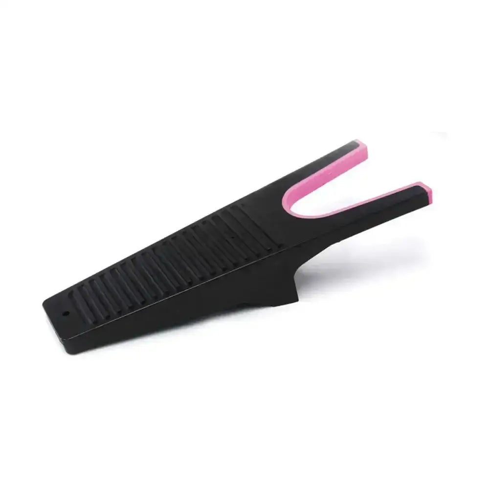 Black and pink rubber equestrian boot jack with textured grip surface for easy removal of muddy boots