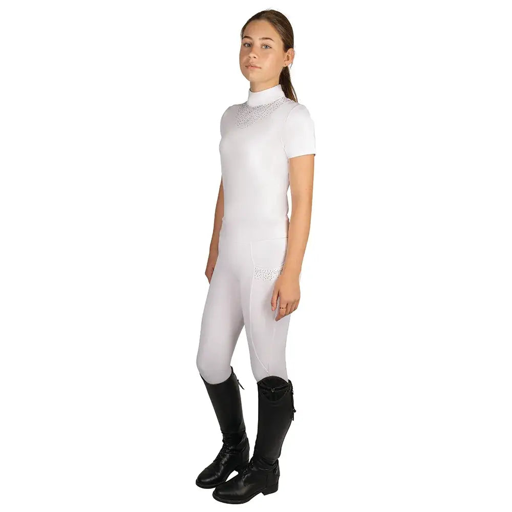White equestrian riding suit with sparkling neckline and hip paired with black boots for children’s roka regal riding