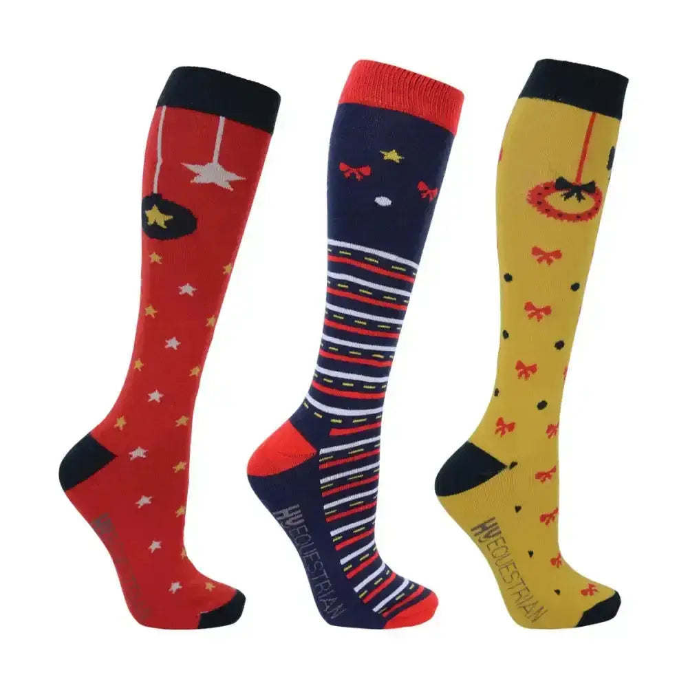 Three festive knee-high equestrian christmas decorations socks in red navy blue and yellow with holiday patterns and striped feet