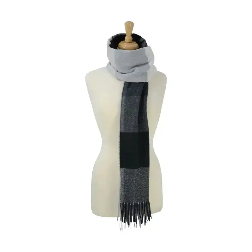 A luxurious soft scarf in gray and black plaid with fringed ends from hy equestrian cumbria soft collection