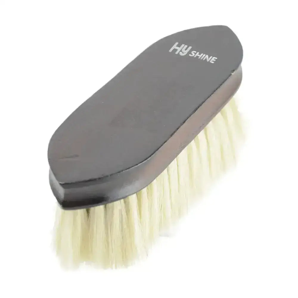 Black-handled hy shine horse brush with dense cream deluxe goat hair bristles on a dark brown lacquered wooden dandy brush