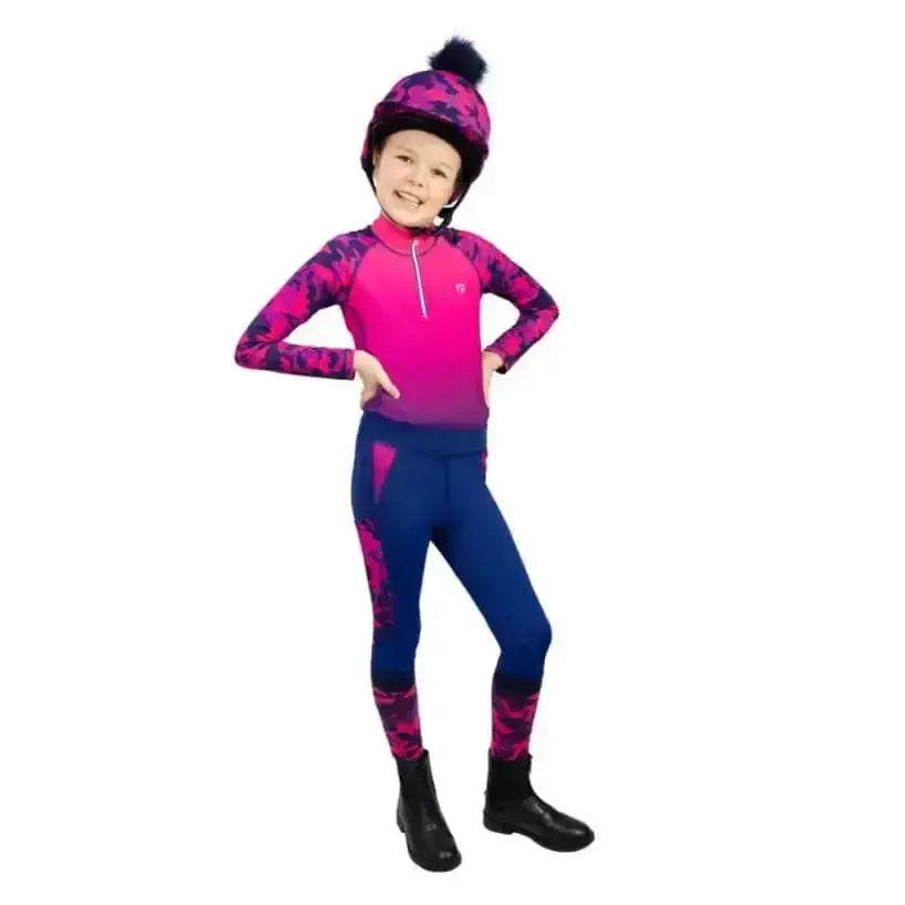 A vibrant pink and purple hy equestrian dynaforce base layer with camouflage print arms and matching helmet with black pom-pom