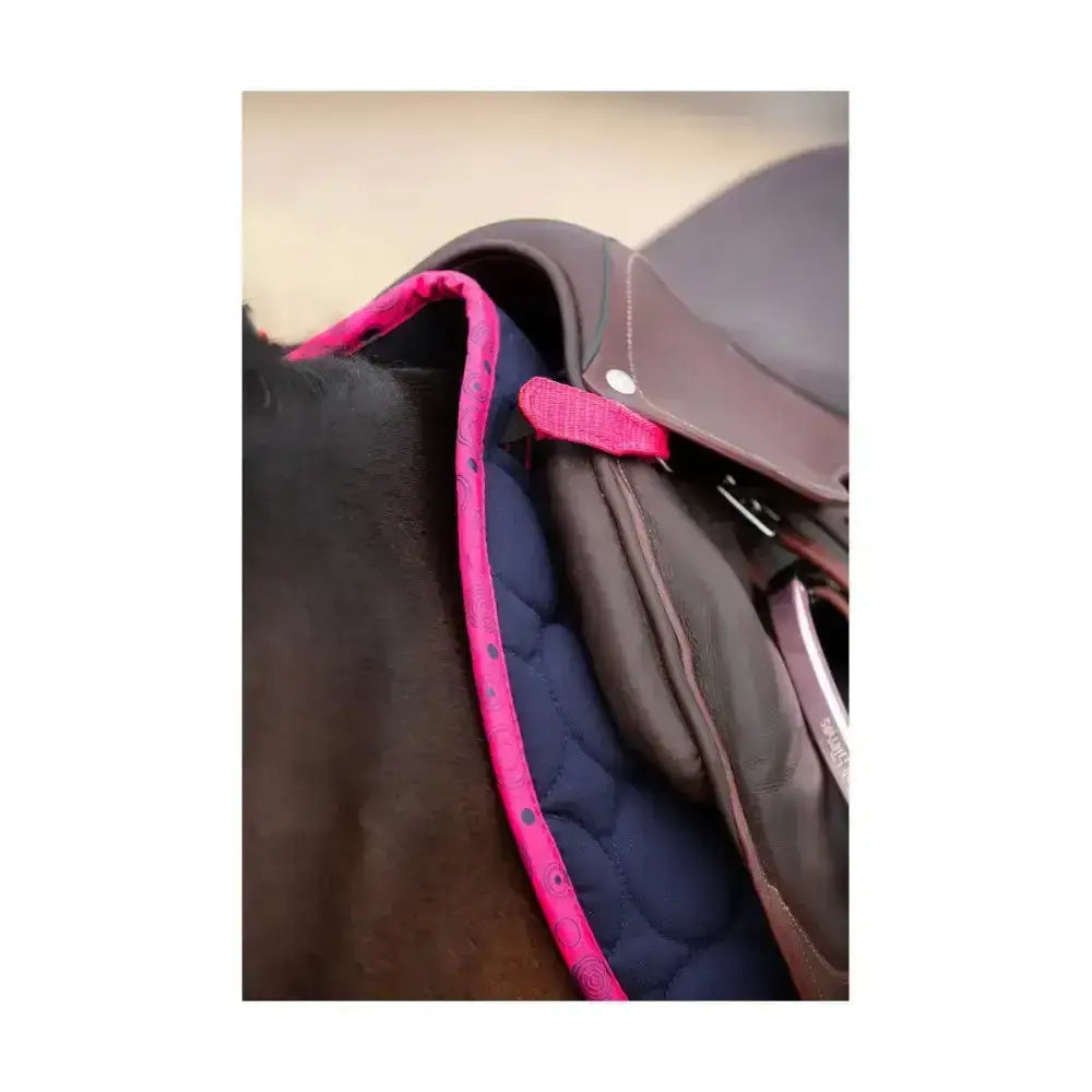 Bright pink padded close contact saddle pad with black polka dots for equestrian dynamizs ecliptic use