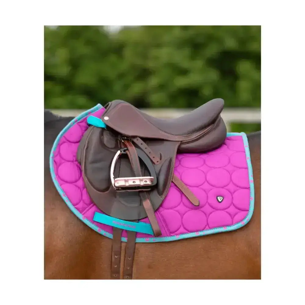 Bright pink quilted equestrian dynamizs ecliptic close contact saddle pad with turquoise border and logo detail