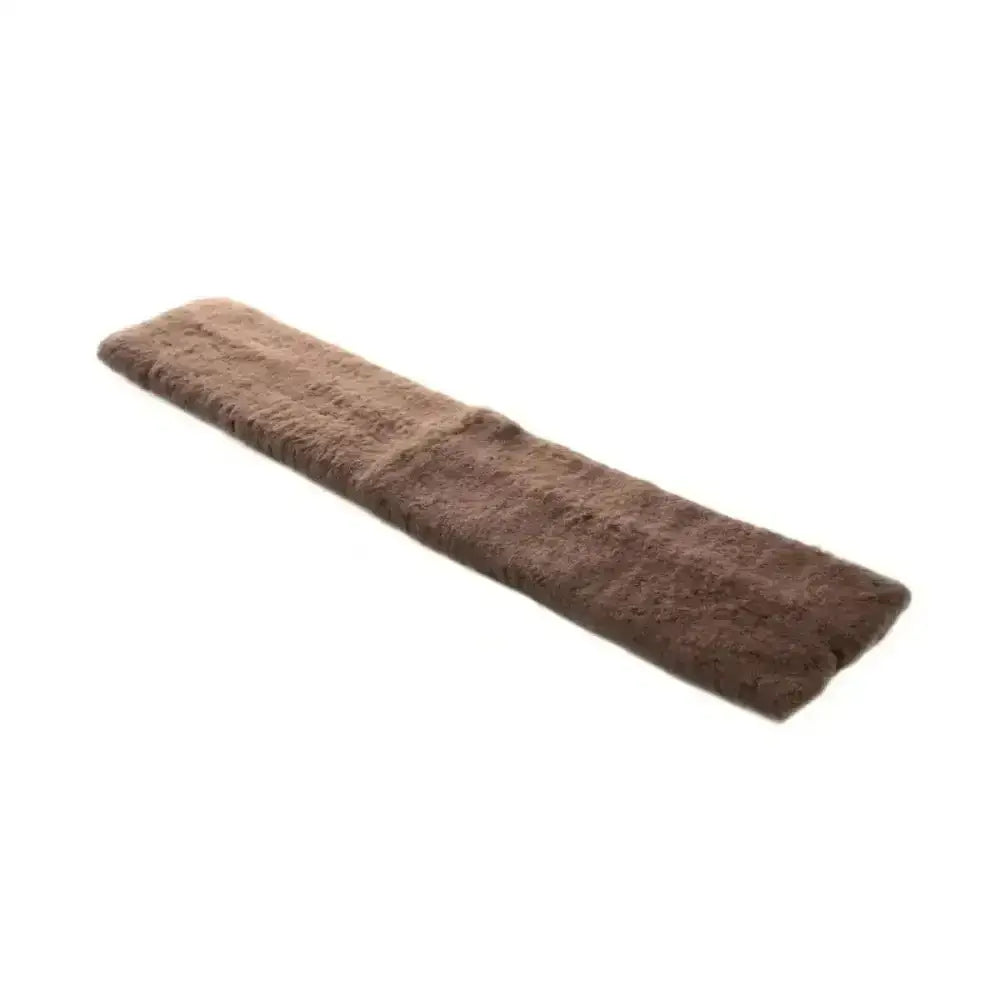 Brown rectangular sheepskin equestrian girth sleeve with plush texture and natural fur edges to prevent girth galls in horse tack