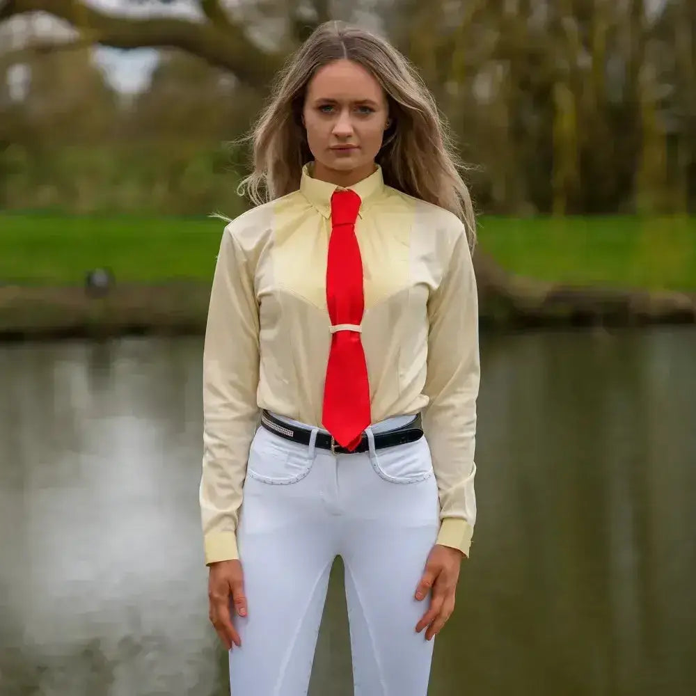 A vibrant red satin tie worn with a pale yellow equestrian ladies dedham long sleeved shirt