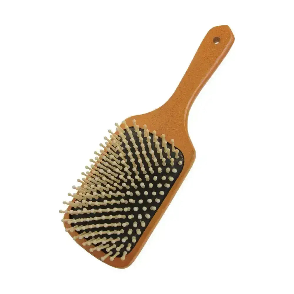 Wooden paddle brush with tan wooden mane bristles and a smooth warm handle for equestrian luxury wooden grooming