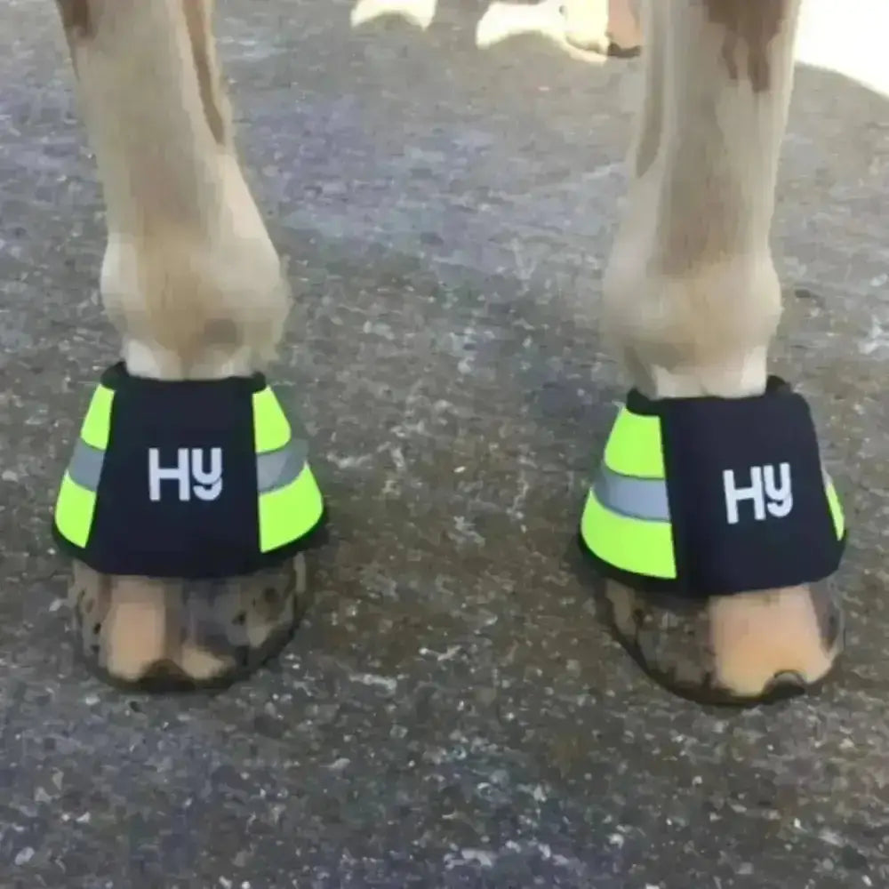 Bright neon green and black hy equestrian reflector over reach boots with fluorescent neoprene and reflective stripes