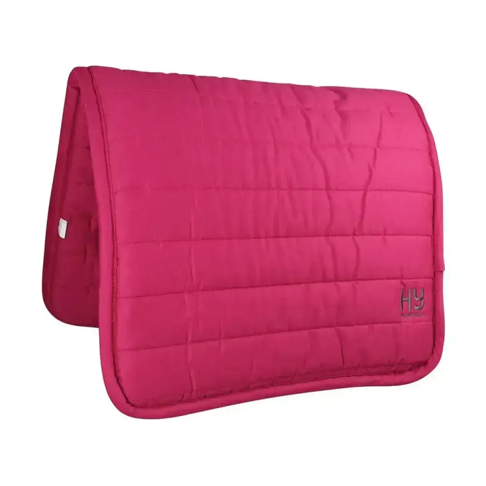 A vibrant fuchsia hy equestrian reversible comfort pad with stitched grid pattern and extra thickness for horses