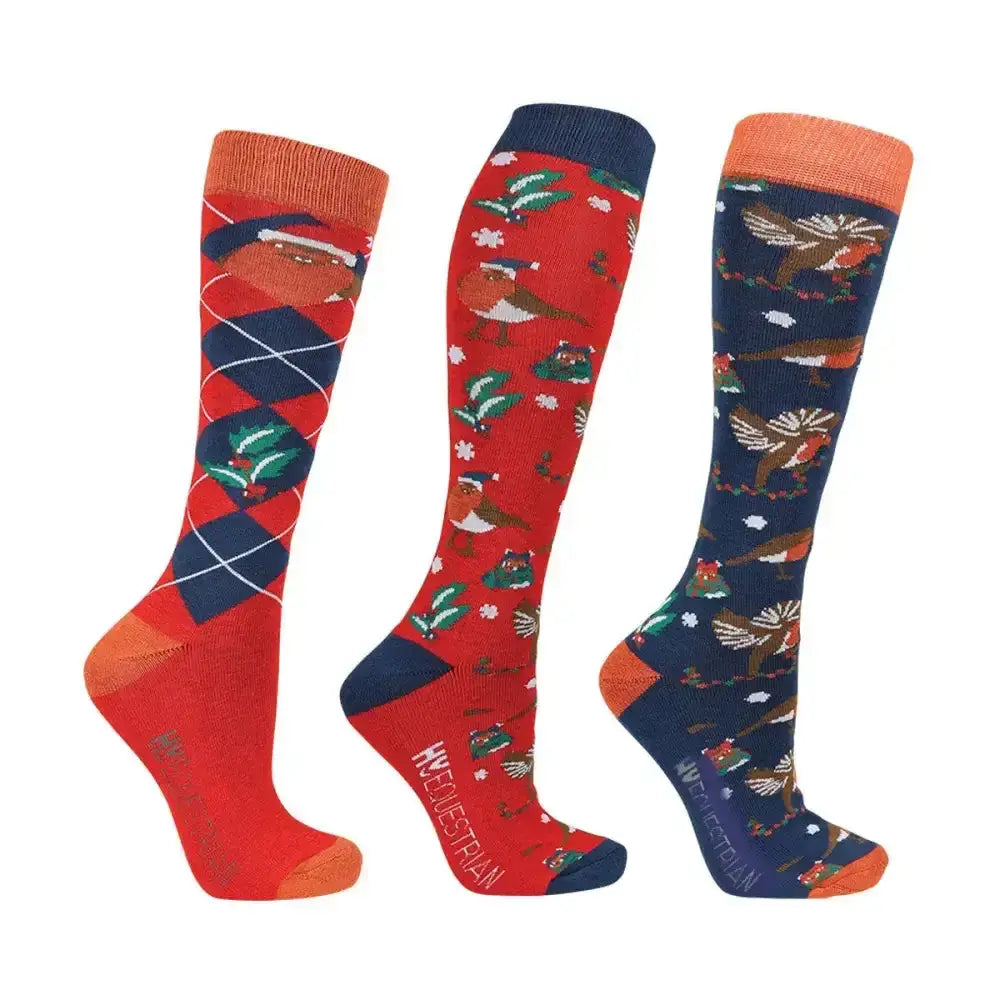 Three festive knee-high equestrian ruby robin christmas socks in red navy and orange with holly and snowflakes designs
