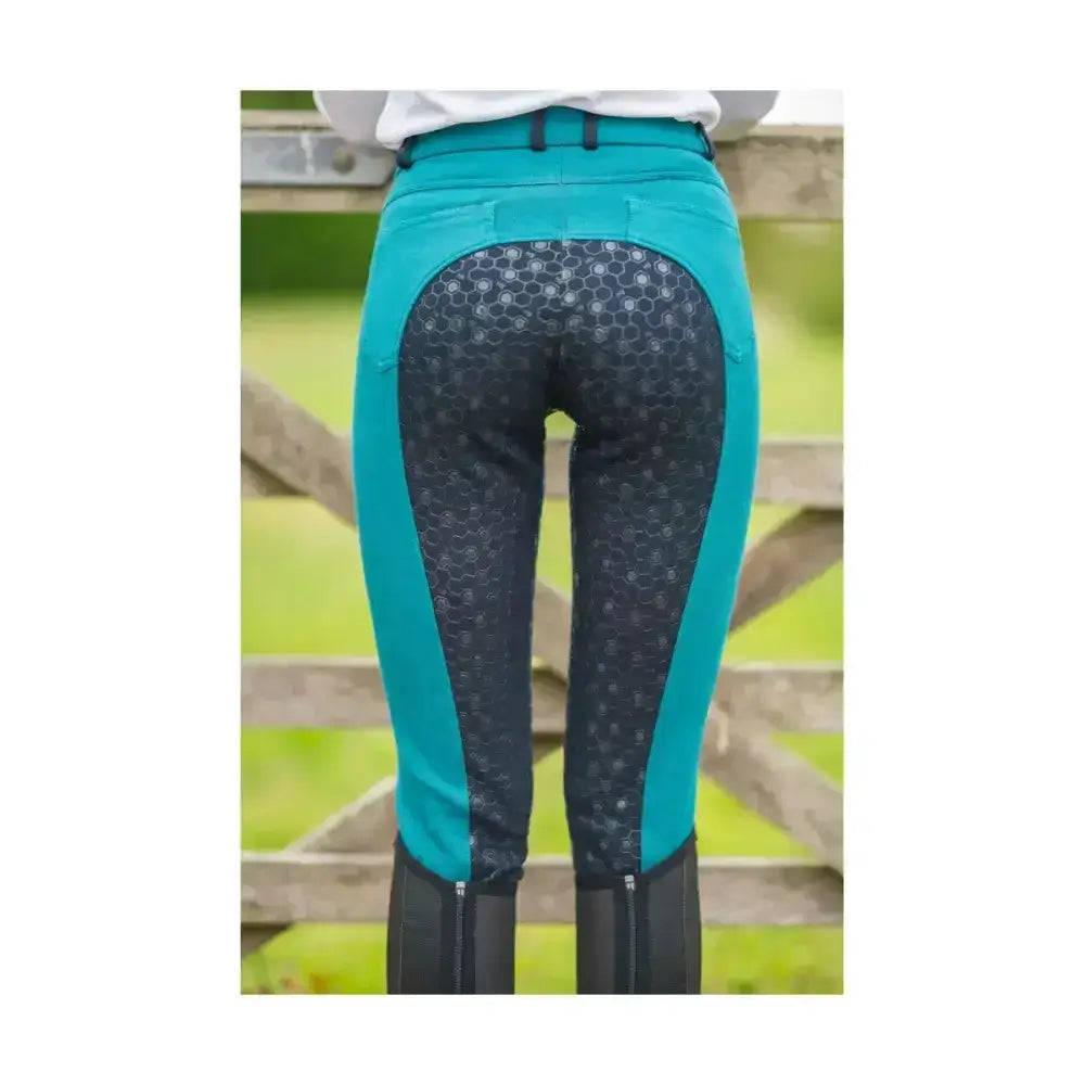 Back view of teal and black equestrian saxby silicone jodhpurs with honeycomb pattern for everyday riding