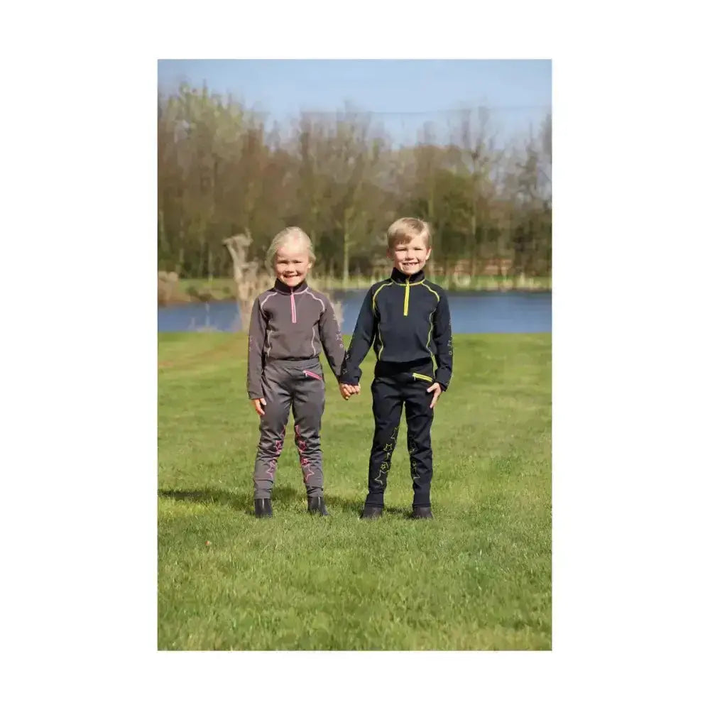 Two kids wearing matching equestrian stella funky base layer outfits in dark gray pink and black neon green details