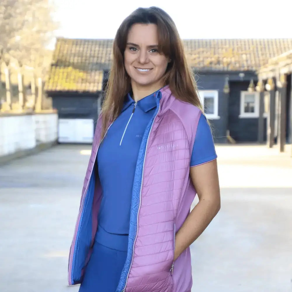 A vibrant purple quilted sync lightweight gilet with blue lining worn over a matching blue top from equestrian synergy elevate