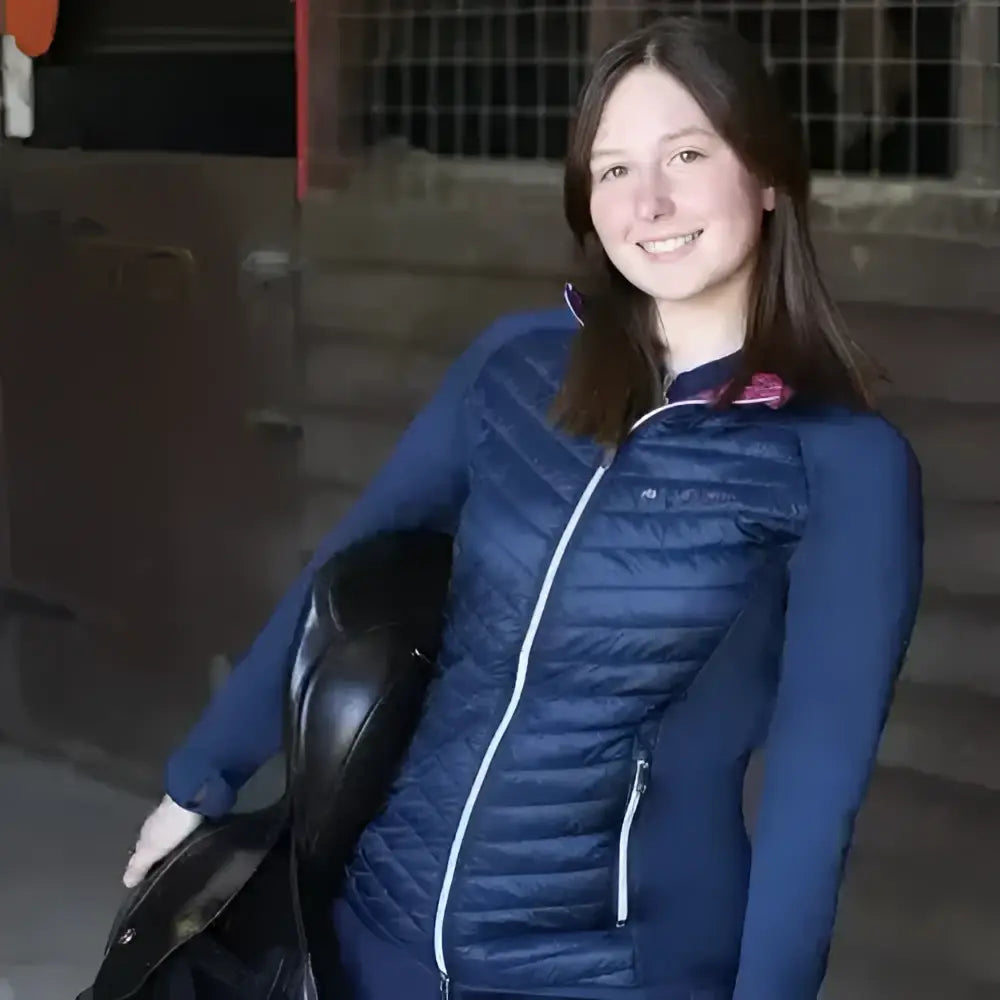 Blue quilted puffer vest with white zipper accents from hy equestrian synergy elevate sync lightweight jacket collection