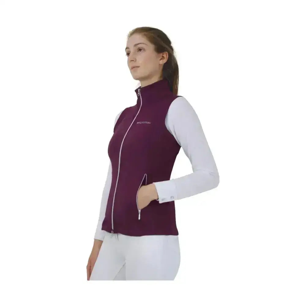 A maroon hy equestrian synergy flex gilet with white zipper accents and 4-way stretch soft fabric for comfort