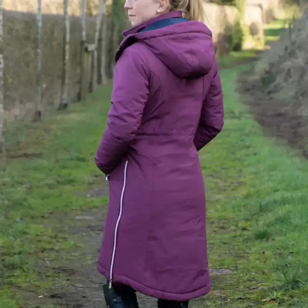 Purple quilted fitted long waterproof equestrian synergy guard coat with hood and white zipper trim