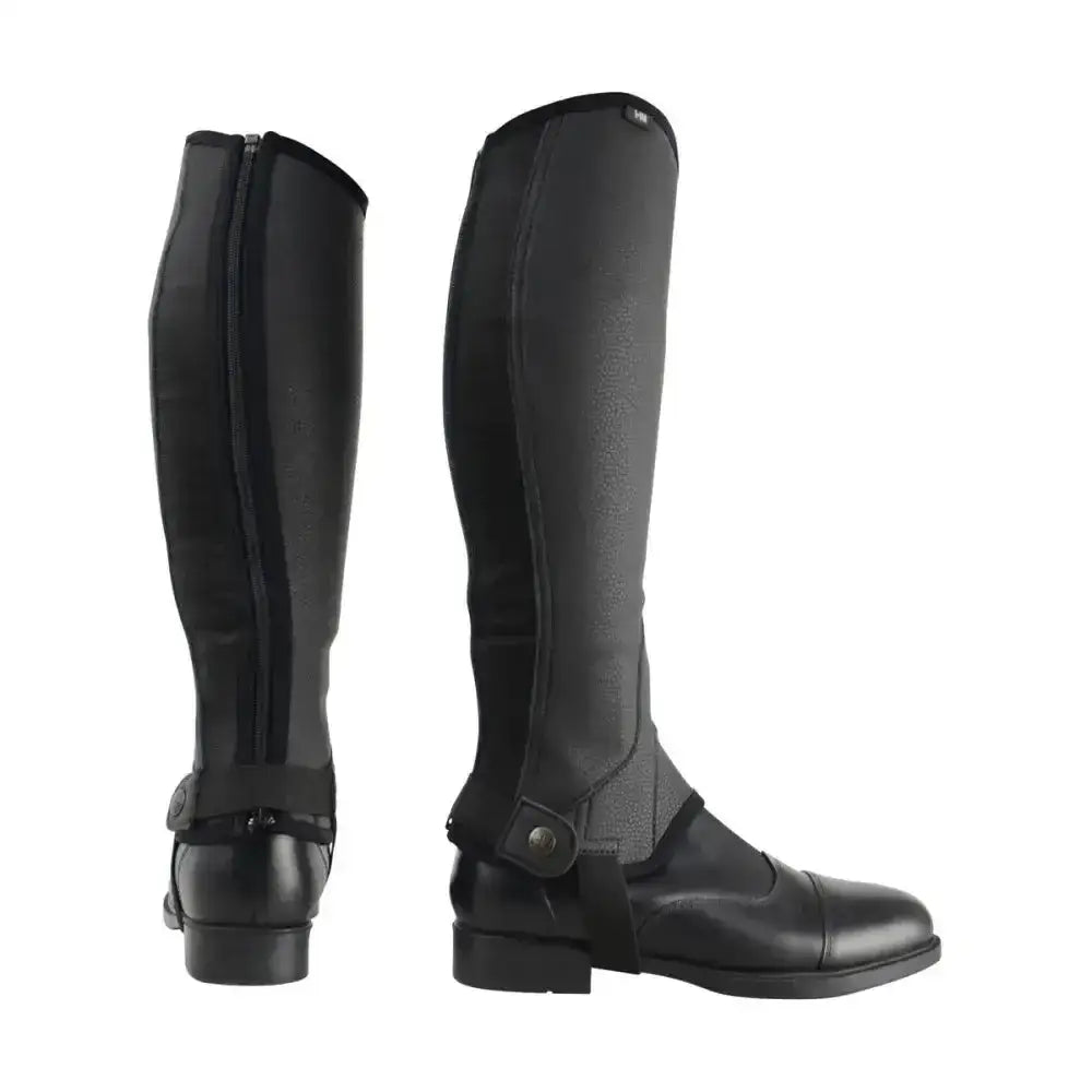 Back view of black hy equestrian synthetic combi leather effect chaps with zipper and adjustable straps