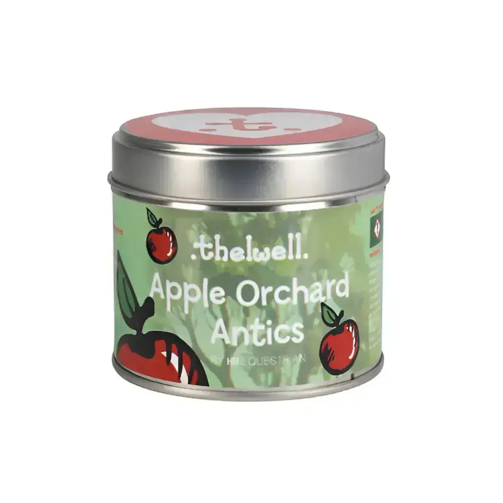 A cylindrical metal tin with a green label featuring red apples from the equestrian thelwell collection long-lasting aromatic candle