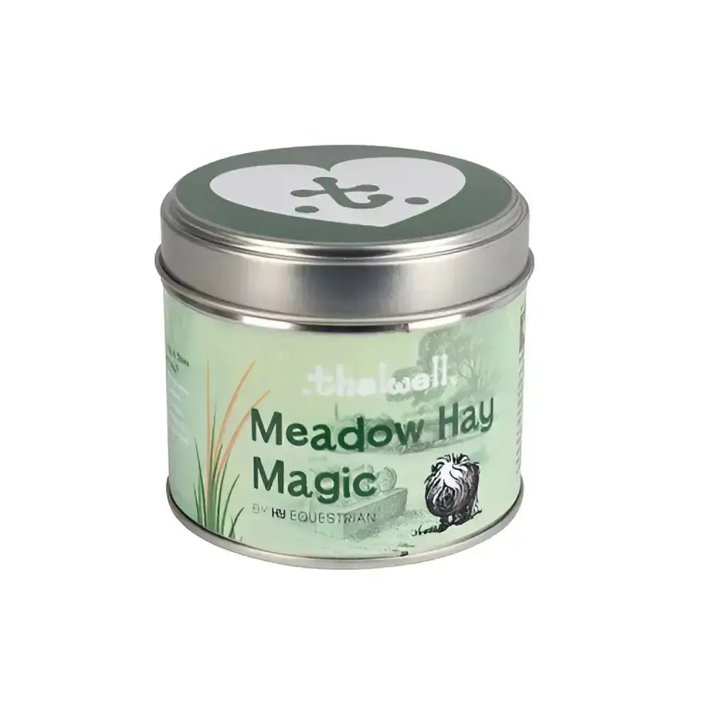 A cylindrical metal tin with a light green meadow hay magic label and silver lid from hy equestrian thelwell collection candle