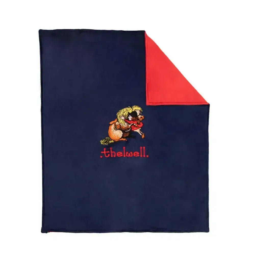 Navy blue fleece blanket with red interior and embroidered cartoon from the equestrian thelwell collection fleece perfect for thelwell lover