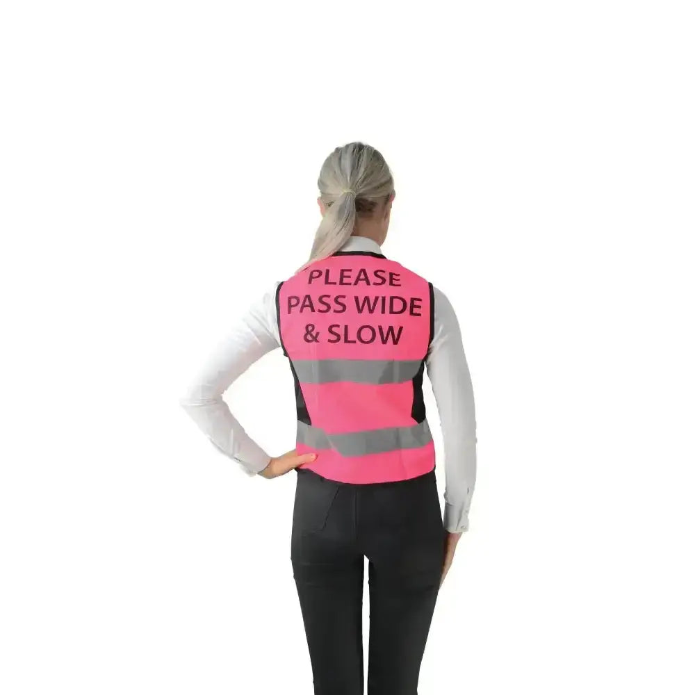Back view of a bright pink hyviz equestrian waistcoat with pass wide and slow text and reflective gray stripes