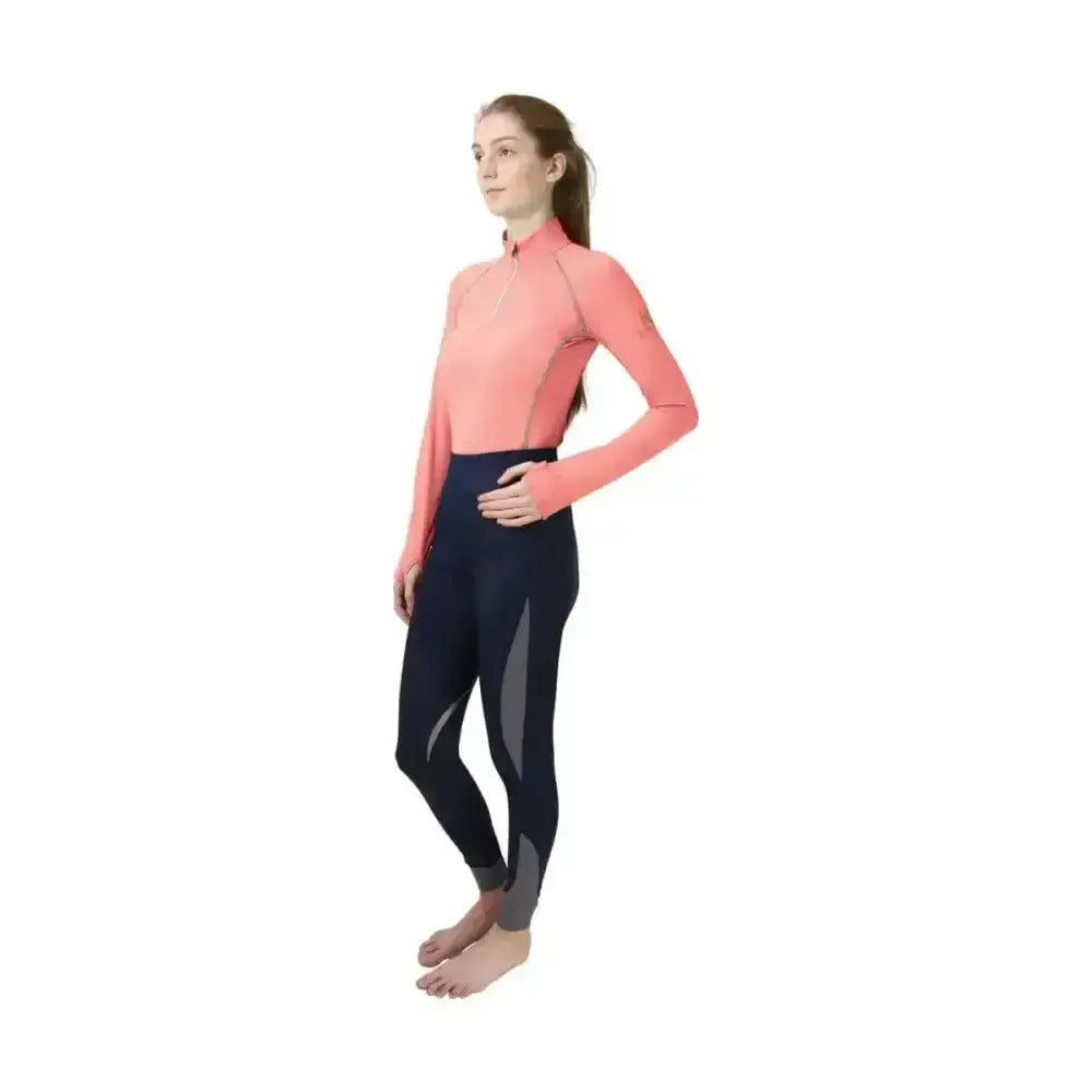 A woman wearing a coral hy sport active base layer top with soft breathable fabric and navy close fit base leggings